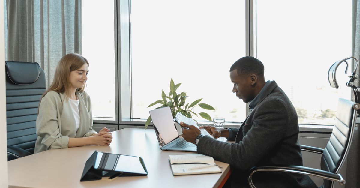 A group of professionals discussing recruitment strategies around a conference table