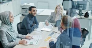 A diverse team of HR professionals discussing recruitment strategies around a conference table